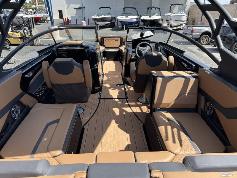 Slide: The Image of 2025 Yamaha Boats 255XD interior with tan seating and modern dashboard design. - 5