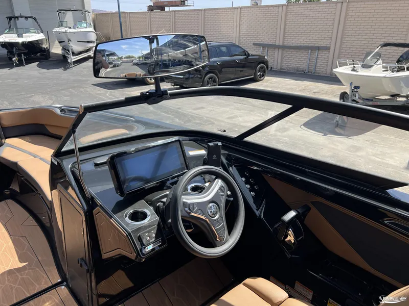 Slide: The Image of Interior view of 2025 Yamaha Boats 255XD, featuring modern dashboard and steering wheel. - 7