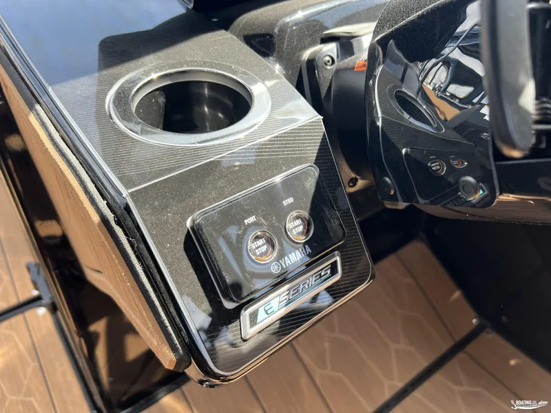 Slide: The Image of Control panel of 2025 Yamaha Boats 255XD with start/stop button and cup holder. - 9