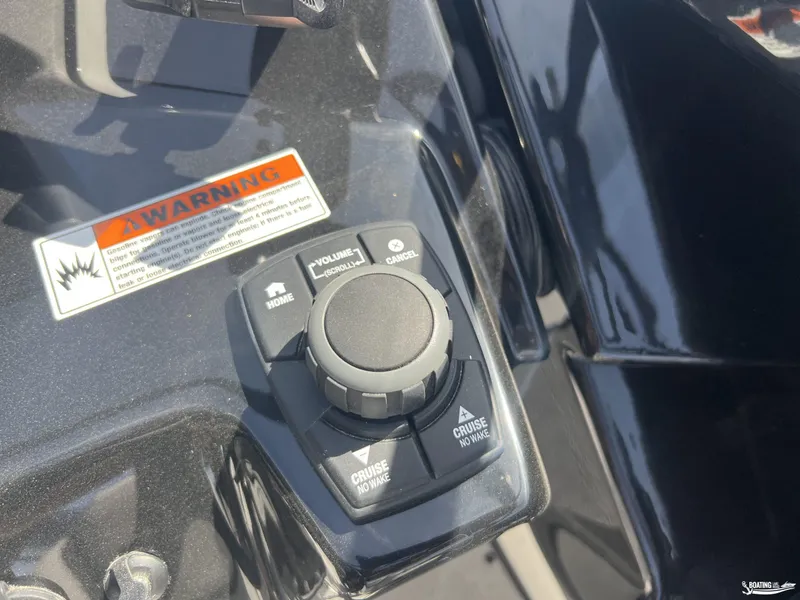 Slide: The Image of Control panel of 2025 Yamaha Boats AR250 with warning label and cruise settings. - 10