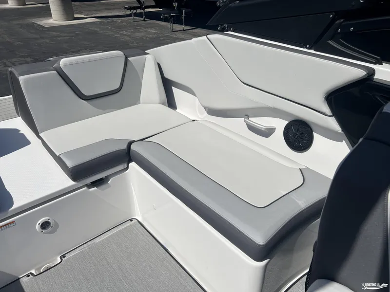 Slide: The Image of 2025 Yamaha Boats AR250 interior seating with sleek gray and white upholstery. - 15