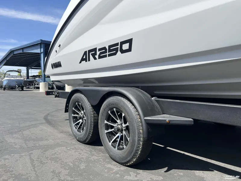 Slide: The Image of 2025 Yamaha Boats AR250 on trailer, showcasing sleek design and modern wheels. - 3
