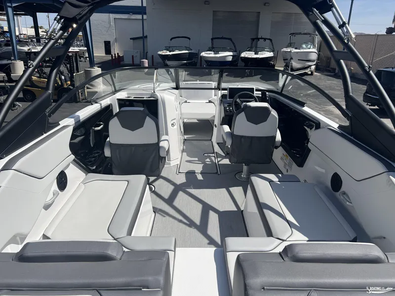 Slide: The Image of 2025 Yamaha Boats AR250 interior with modern seating and steering console. - 5