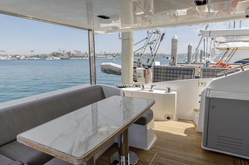 Slide: The Image of Azimut 60 Flybridge 2021 yacht with elegant outdoor seating and marina view. - 17