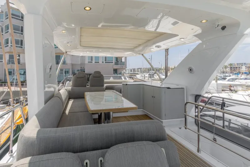 Slide: The Image of Azimut 60 Flybridge 2021 yacht interior with elegant seating and dining area. - 23