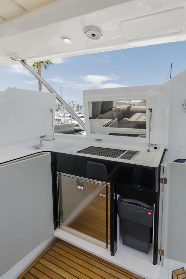 Slide: The Image of 2021 Azimut 60 Flybridge yacht kitchenette with modern appliances and sleek design. - 26