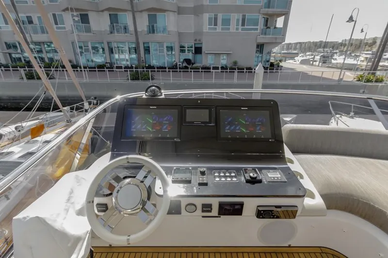 Slide: The Image of Azimut 60 Flybridge 2021 yacht helm with modern navigation displays and controls. - 28