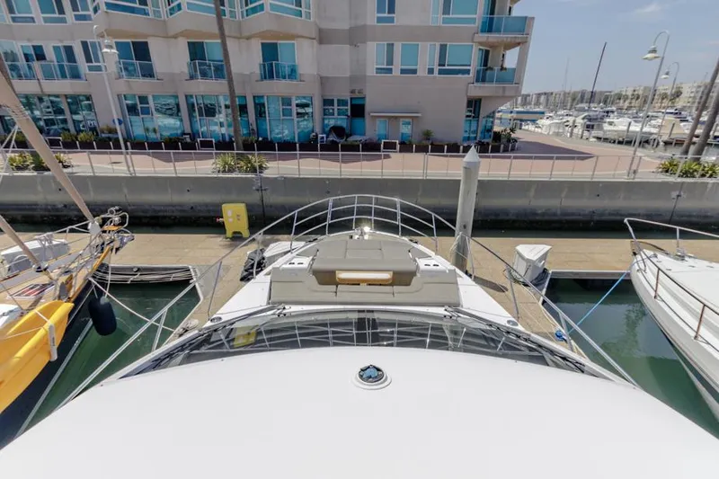 Slide: The Image of Azimut 60 Flybridge 2021 docked near modern waterfront building. - 29
