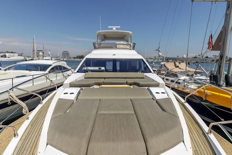 Slide: The Image of 2021 Azimut 60 Flybridge yacht docked in marina, showcasing spacious deck and sleek design. - 39