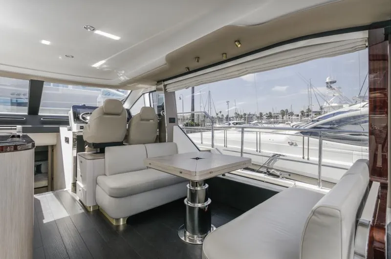 Slide: The Image of Luxurious interior of 2021 Azimut 60 Flybridge yacht with elegant seating and marina view. - 42