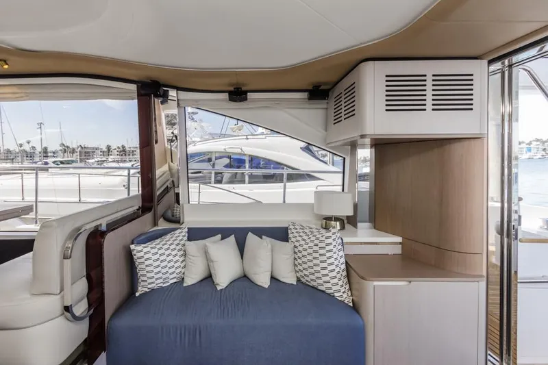 Slide: The Image of Interior of 2021 Azimut 60 Flybridge yacht with modern seating and window view. - 44