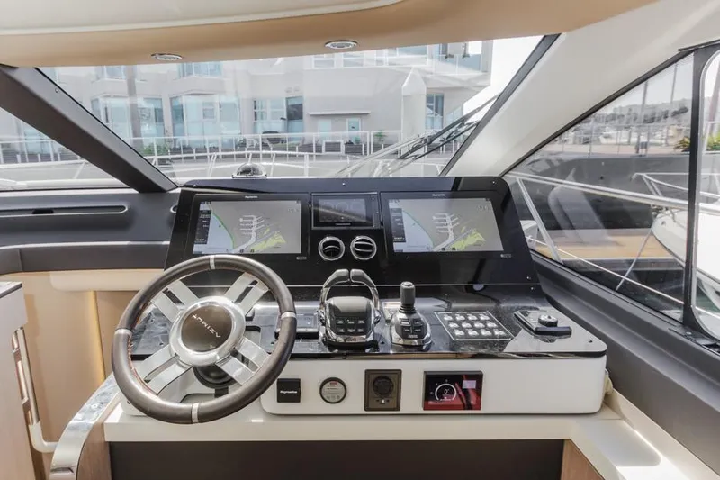 Slide: The Image of Azimut 60 Flybridge 2021 yacht helm with modern navigation controls and displays. - 48