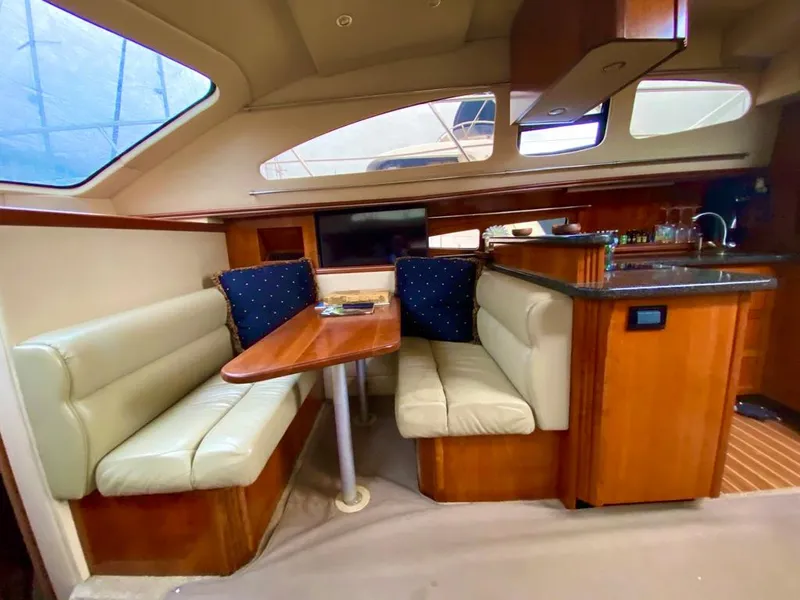 Slide: The Image of Luxurious 2005 Cruisers Yachts 405 Express Motoryacht interior with dining area and kitchenette. - 18
