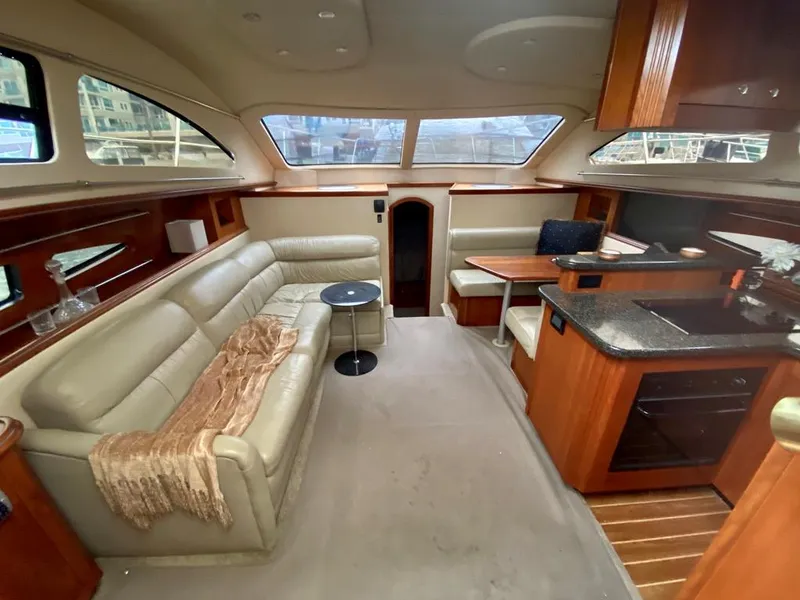 Slide: The Image of Luxurious 2005 Cruisers Yachts 405 Express Motoryacht interior with elegant seating and kitchen area. - 19