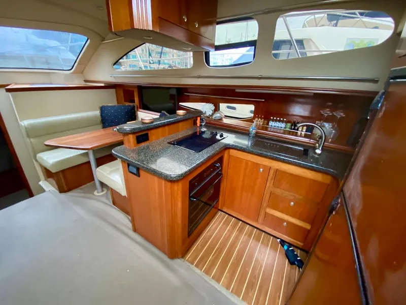 Slide: The Image of Luxurious 2005 Cruisers Yachts 405 Express Motoryacht interior with modern kitchen and dining area. - 22