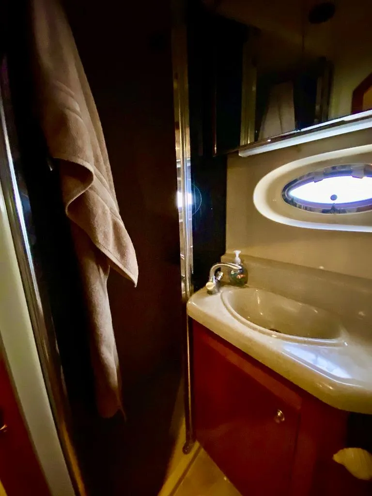 Slide: The Image of 2005 Cruisers Yachts 405 Express Motoryacht bathroom with sink and towel. - 28