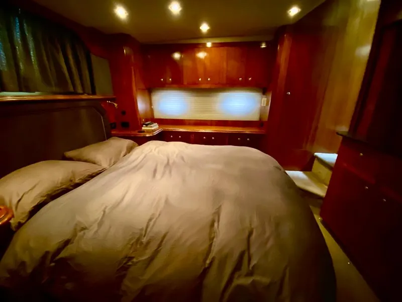 Slide: The Image of Luxurious bedroom in 2005 Cruisers Yachts 405 Express Motoryacht with wood cabinetry and ambient lighting. - 29