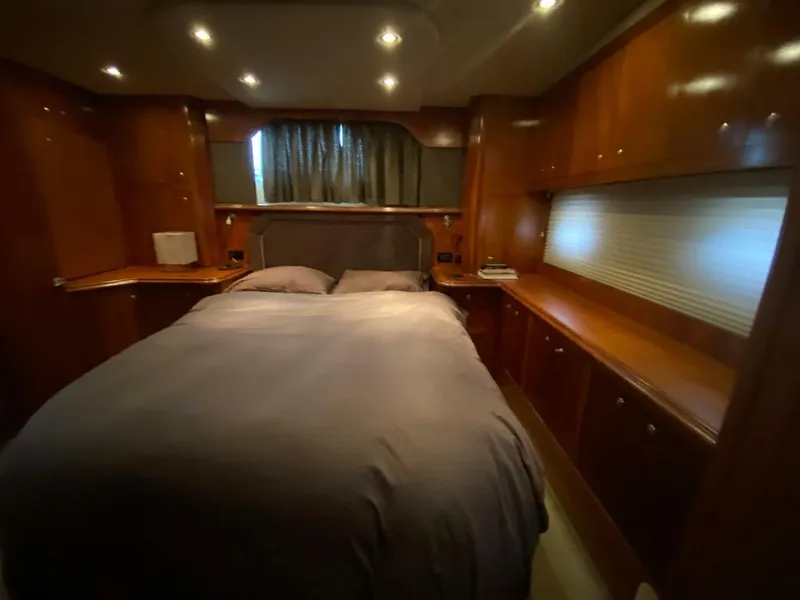 Slide: The Image of Luxurious bedroom in 2005 Cruisers Yachts 405 Express Motoryacht with wood cabinetry and ambient lighting. - 32