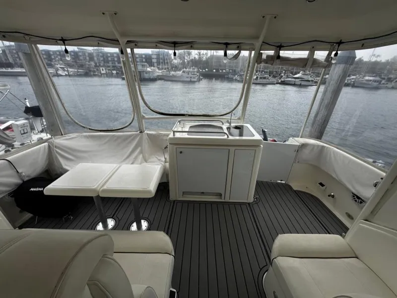 Slide: The Image of 2005 Cruisers Yachts 405 Express Motoryacht interior with seating and kitchenette, overlooking marina. - 40