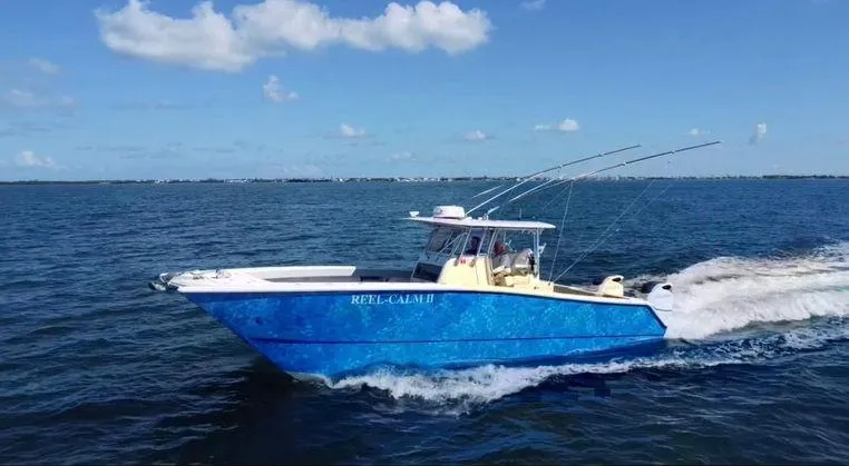 Slide: The Image of Freeman 34VH 2020 boat cruising on open water under a clear blue sky. - 0