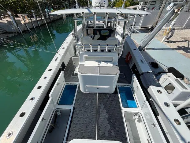 Slide: The Image of 2020 Freeman 34VH boat with spacious deck, advanced controls, and storage compartments, docked by clear water. - 10