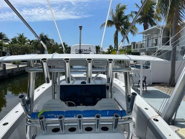 Slide: The Image of 2020 Freeman 34VH boat with Garmin equipment, docked near palm trees. - 12