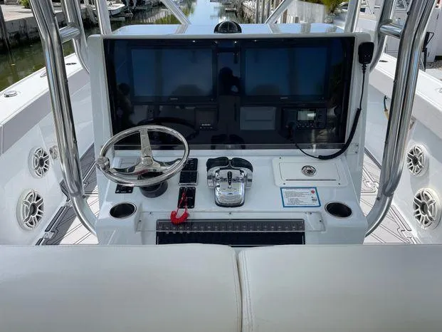 Slide: The Image of Freeman 34VH 2020 boat helm with steering wheel, controls, and navigation screens. - 14