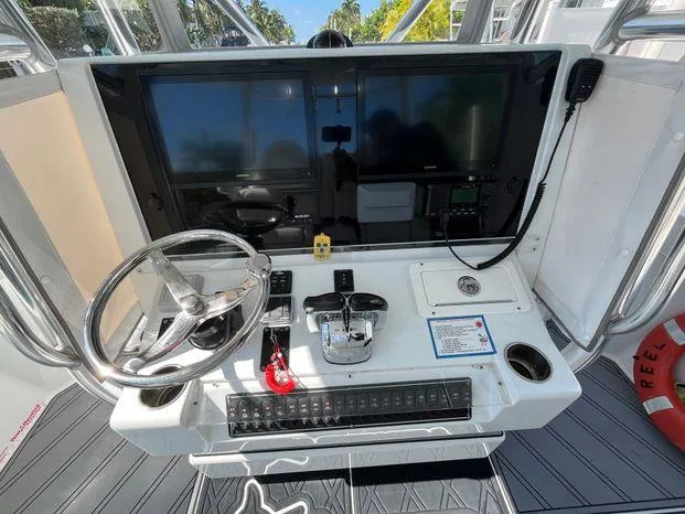 Slide: The Image of Control panel of a 2020 Freeman 34VH boat with steering wheel and navigation screens. - 15