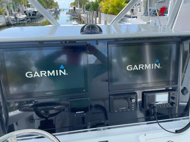 Slide: The Image of Freeman 34VH 2020 boat dashboard with dual Garmin displays and navigation equipment. - 16