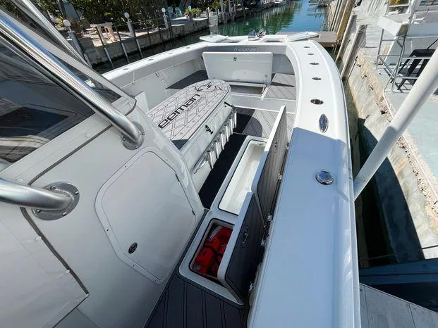 Slide: The Image of 2020 Freeman 34VH boat with spacious deck and storage compartments, docked by a canal. - 20