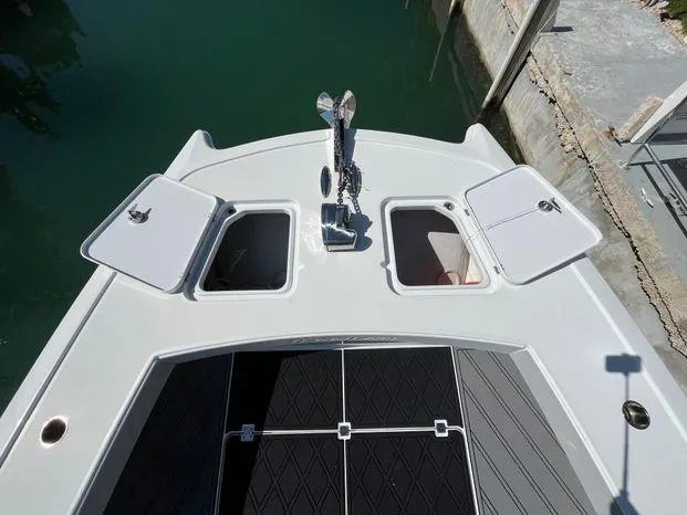 Slide: The Image of Bow view of a 2020 Freeman 34VH boat with open storage compartments. - 24
