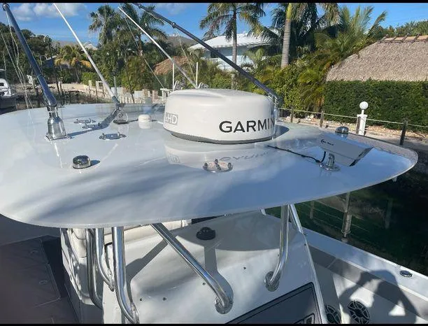 Slide: The Image of Freeman 34VH 2020 boat with Garmin radar, docked near tropical foliage. - 25