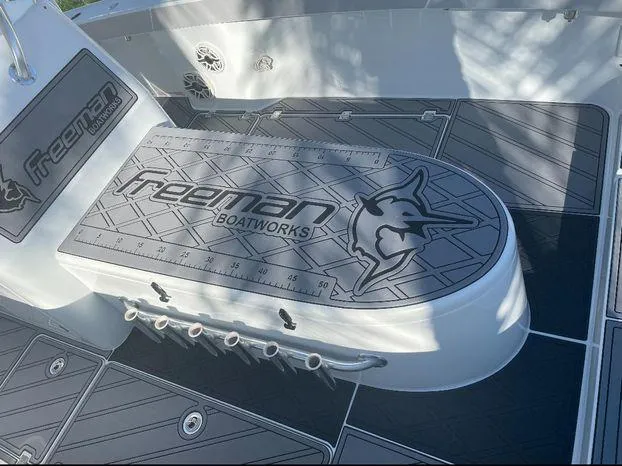 Slide: The Image of Freeman 34VH 2020 boat deck with custom logo and fishing rod holders. - 26