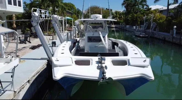 Slide: The Image of Freeman 34VH 2020 boat docked in a canal, surrounded by lush greenery. - 4