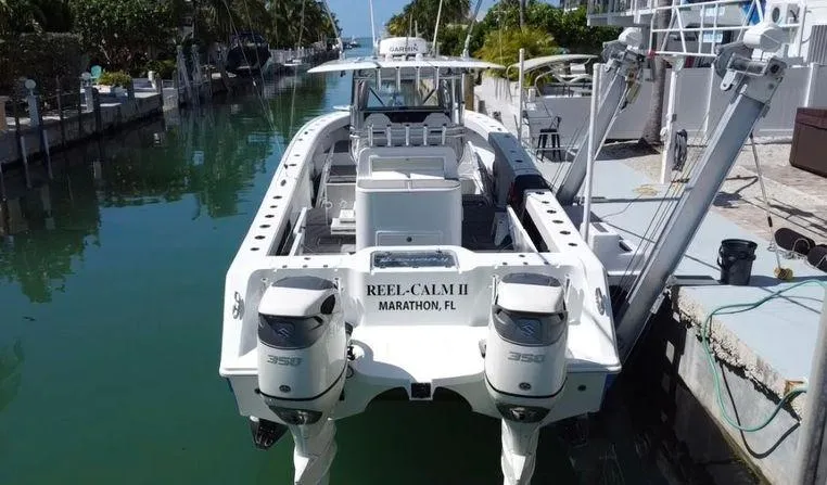 Slide: The Image of Freeman 34VH 2020 boat docked in a canal, featuring twin engines. - 7