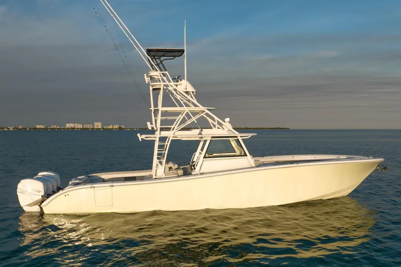 Slide: The Image of 2021 Yellowfin 42 boat on calm water at sunset. - 0