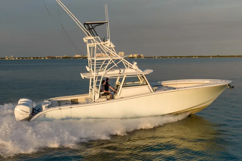 Slide: The Image of 2021 Yellowfin 42 boat cruising on open water at sunset. - 10