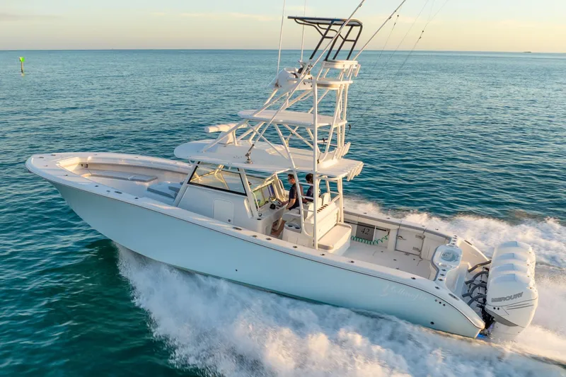 Slide: The Image of 2021 Yellowfin 42 boat cruising on open water, showcasing sleek design and powerful engines. - 12