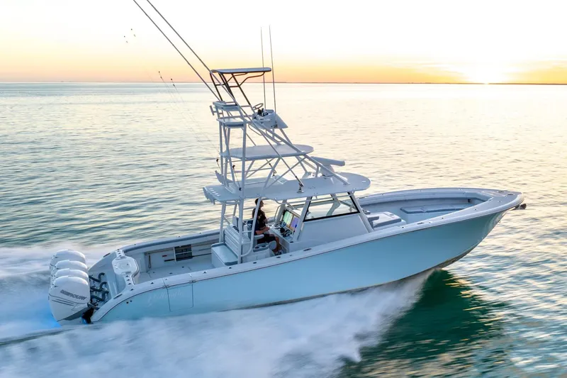 Slide: The Image of 2021 Yellowfin 42 boat cruising at sunset on calm ocean waters. - 13