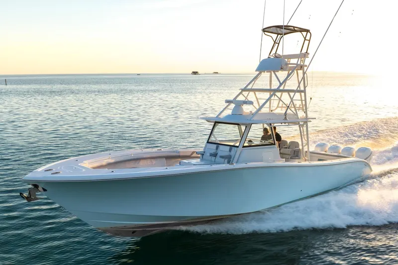 Slide: The Image of 2021 Yellowfin 42 boat cruising on open water at sunset. - 14