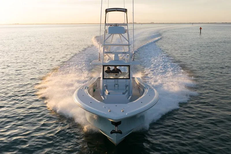 Slide: The Image of 2021 Yellowfin 42 boat cruising on open water at sunset. - 16
