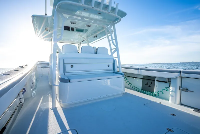 Slide: The Image of 2021 Yellowfin 42 boat interior with seating, ocean view, and clear sky. - 20