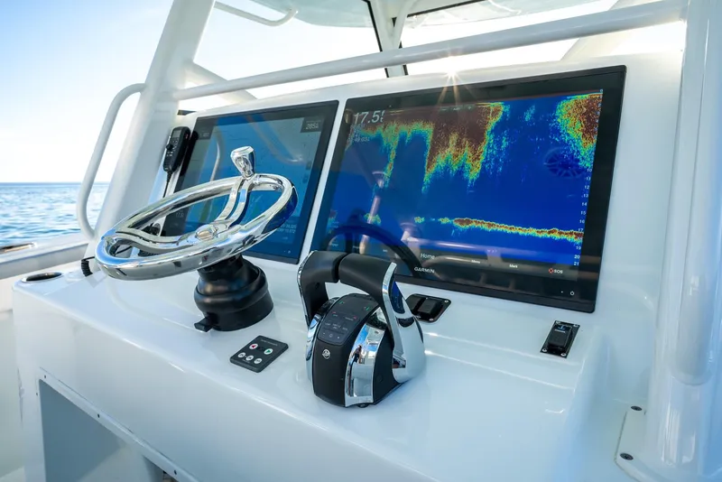 Slide: The Image of 2021 Yellowfin 42 boat dashboard with advanced navigation screens and controls. - 27