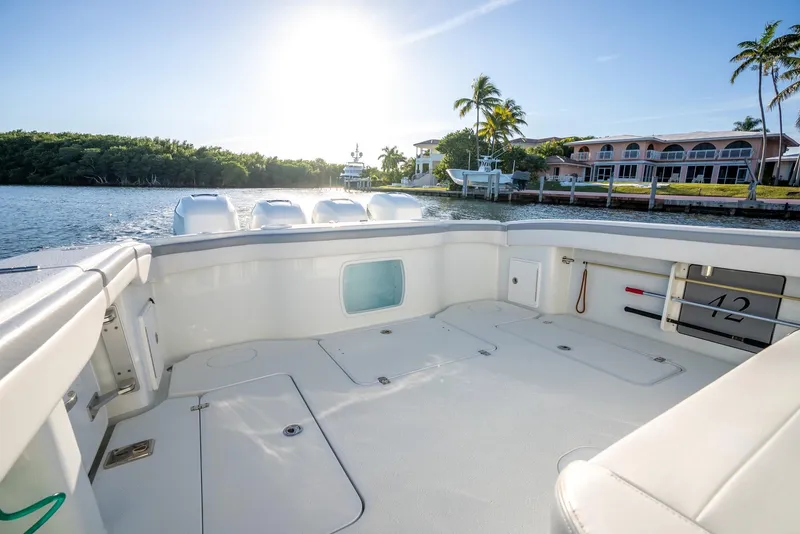 Slide: The Image of 2021 Yellowfin 42 boat deck with scenic waterfront view and palm trees. - 28