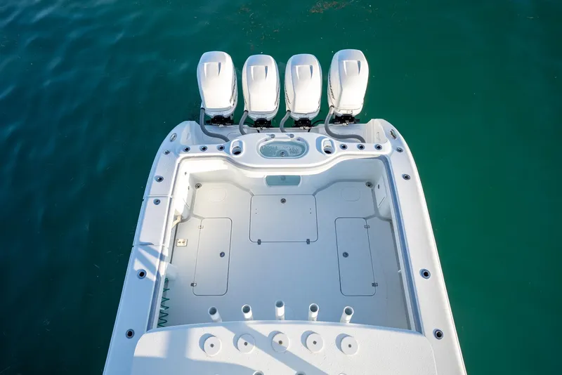 Slide: The Image of 2021 Yellowfin 42 boat with four powerful outboard engines on clear water. - 30
