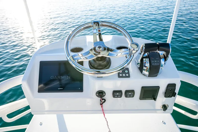 Slide: The Image of Steering console of 2021 Yellowfin 42 boat with Garmin display on calm water. - 37