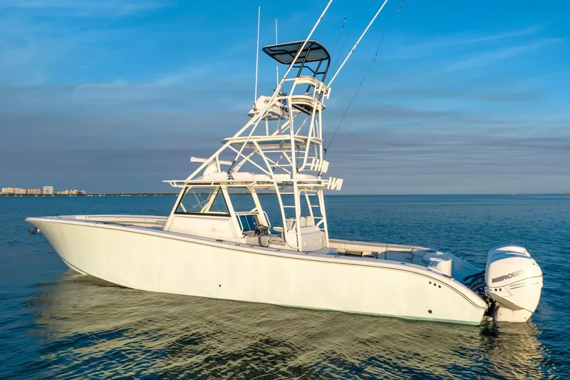 Slide: The Image of 2021 Yellowfin 42 boat on calm water, featuring a sleek design and powerful engines. - 4