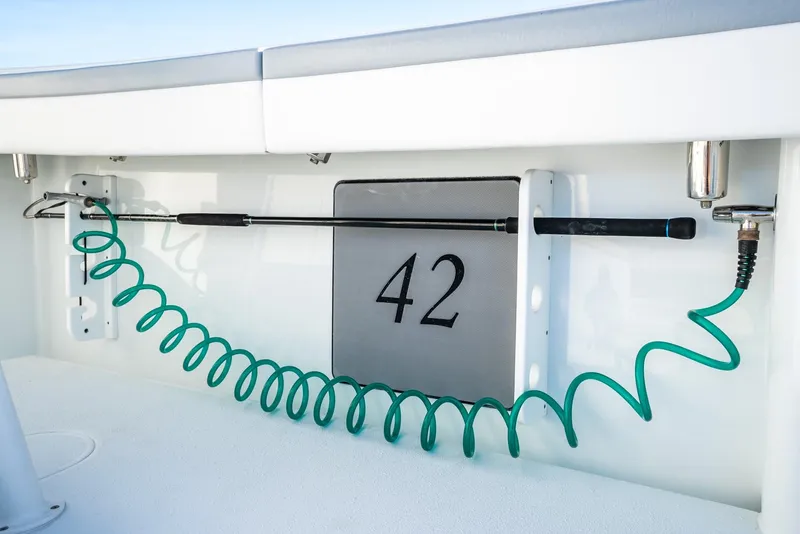 Slide: The Image of 2021 Yellowfin 42 boat detail with coiled hose and rod holder. - 45