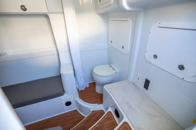 Slide: The Image of 2021 Yellowfin 42 boat interior with toilet, seating, and wood flooring. - 47