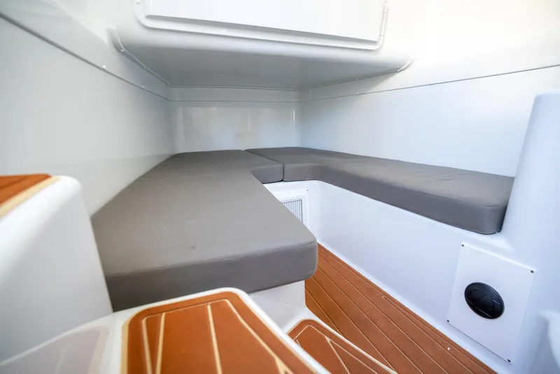 Slide: The Image of Interior cabin of 2021 Yellowfin 42 boat with cushioned seating and wooden flooring. - 48